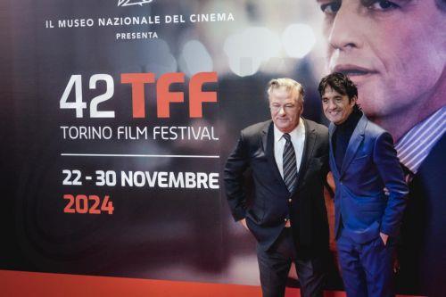 epa11739846 US actor Alec Baldwin (L) poses with festival director Giulio Base on the red carpet on occasion of receiving the Stella della Mole Award during the 42nd Torino Film Festival (TFF), in Turin, Italy, 25 November 2024. The film festival runs from 22 to 30 November 2024.  EPA/TINO ROMANO / YU8