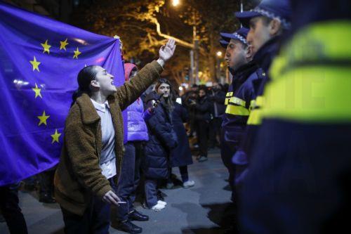epa11745744 A Georgian opposition supporter gestures next to an EU flag during a protest in front of the office of the Georgian Dream ruling party in Tbilisi, Georgia, 28 November 2024. Georgian Prime Minister Irakli Kobakhidze said on 28 November that Tbilisi will refuse EU accession talks until 2028. On 26 October 2024, parliamentary elections were held...