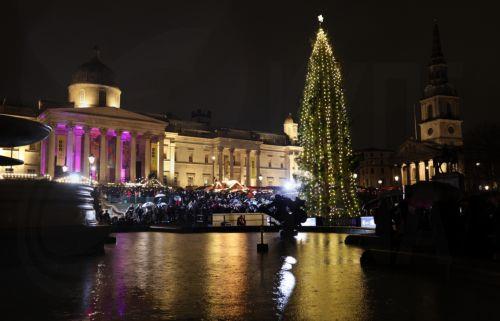 epa11759049 London's Trafalgar Square Christmas tree is lit up at Trafalgar Square in London, Britain, 05 December 2024. Since 1947, Norway has gifted London with a Norwegian spruce tree as a thank-you for Britain's support during WWII. The tree is approximately 60 years old, 20 meters high and weighs about 1,200 kilos.  EPA/ANDY RAIN