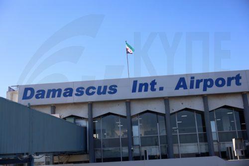 epa11783431 The three-star opposition flag flutters over the Damascus International Airport after it was reponed for the first time since the ouster of president Bashar al-Assad, Damascus, Syria, 18 December 2024. A Syrian Air Airbus plane took off from Damascus airport to Aleppo in the countryâ€™s north for the first time since opposition forces seized the...
