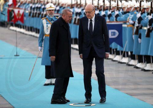 epa11783946 Turkish President Recep Tayyip Erdogan (L) and Lebanese Prime Minister Najib Mikati (R) review a guard of honor during a welcome ceremony at the Presidential Palace in Ankara, Turkey, 18 December 2024.  EPA/NECATI SAVAS