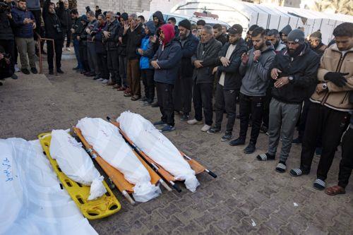 epa11801983 Palestinians pray next to the bodies of their relatives killed during an Israeli airstrike on an internally displaced persons camp in Al-Mawasi area, west of Khan Yunis, southern Gaza Strip, 02 January 2025. Ten Palestinians were killed in the airstrike, according to the local Nasser Hospital. According to the UN, at least 1.9 million people (or...