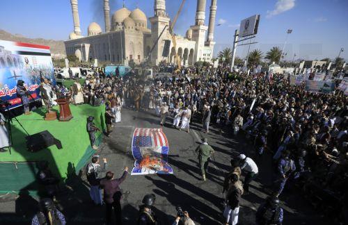 epa11817132 Houthi supporters burn a banner depicting the US and Israeli flags during an anti-US and anti-Israel protest in Sana'a, Yemen, 10 January 2025. Thousands of Houthi supporters gathered in Sana'a to protest against the latest Israeli strikes targeting Houthi-controlled sites in Yemen, amid the escalation of Houthi attacks on Israel and commercial...
