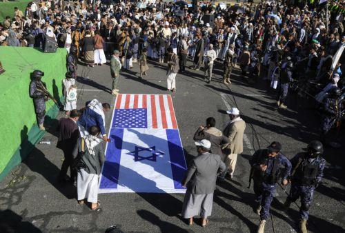 epa11817140 Houthi supporters prepare to burn a banner depicting the US and Israeli flags during an anti-US and anti-Israel protest in Sana'a, Yemen, 10 January 2025. Thousands of Houthi supporters gathered in Sana'a to protest against the latest Israeli strikes targeting Houthi-controlled sites in Yemen, amid the escalation of Houthi attacks on Israel and...