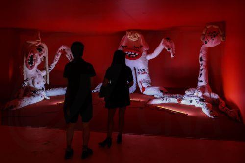 epa11824958 People look at artworks in the exhibition 'Te amo, Mon Laferte Visual' by Chilean artist Mon Laferte at the Valparaiso Cultural Park, in Valparaiso, Chile, 14 January 2025. Chilean singer and artist Mon Laferte was named cultural ambassador of Valparaiso.  EPA/Cristobal Basaure