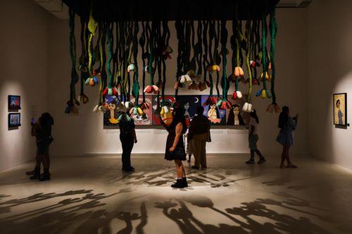 epa11824959 People look at artworks in the exhibition 'Te amo, Mon Laferte Visual' by Chilean artist Mon Laferte at the Valparaiso Cultural Park, in Valparaiso, Chile, 14 January 2025. Chilean singer and artist Mon Laferte was named cultural ambassador of Valparaiso.  EPA/Cristobal Basaure