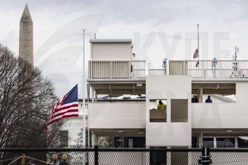 epa11834757 People on a structure that was built for Mondayâ€™s inauguration ceremonies across the street from the White House in Washington, DC, USA, 18 January 2025. President-elect Donald Trump, who defeated Joe Biden to become the 47th president of the United States, will be inaugurated on Monday 20 January, though all of the carefully planned outdoor...