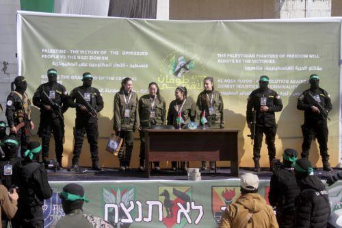 epa11851212 (L-R) Israeli hostages Naama Levy, Liri Albag, Daniella Gilboa and Karina Ariev stand on a stage before being delivered to the representative of the International Committee of the Red Cross (ICRC) by Hamas militants, as they are released from the Gaza Strip, in Gaza City, 25 January 2025. The four Israeli hostage soldiers Liri Albag, Naama Levy,...