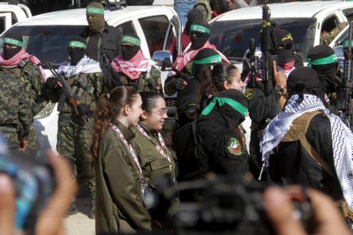 epa11851214 (L-R) Israeli hostages Naama Levy, Liri Albag and Karina Ariev walk before being delivered to the representative of the International Committee of the Red Cross (ICRC) by Hamas militants, as they are released from the Gaza Strip, in Gaza City, 25 January 2025. The four Israeli hostage soldiers Liri Albag, Naama Levy, Karina Ariev, and Daniella...