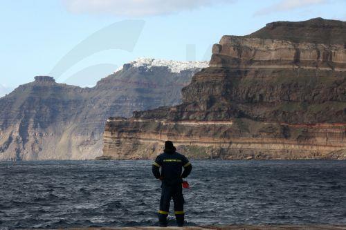 epa11879094 A firefighter from the Greek Fire and Rescue Service (EMAK) stands at the port of Santorini where a ship from the port of Piraeus is about to arrive, in Santorini, Greece, 06 February 2025. The municipality of Thera (Santorini) has declared a state of emergency due to a wave of seismic activity, taking effect from 01 February to 01 March. More...