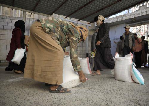 epa11879328 People receive rations of food aid, provided by Mona Relief agency, amid food insecurity, in Sana'a, Yemen, 06 February 2025. According to the United Nations' 2025 Yemen Humanitarian Needs and Response Plan, the humanitarian situation in Yemen remains dire, with 19.5 million people out of the war-torn country's over 30 million population...