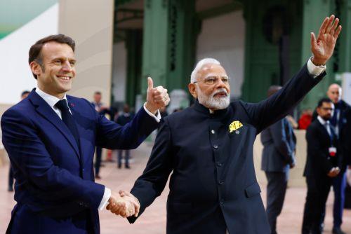 epa11888385 French President Emmanuel Macron (L) and Indian Prime Minister Narendra Modi (R) wave prior to a plenary session during a plenary session of the Artificial Intelligence (AI) Action Summit at the Grand Palais in Paris, France, 11 February 2025. The summit takes place from 10 to 11 February.  EPA/MOHAMMED BADRA