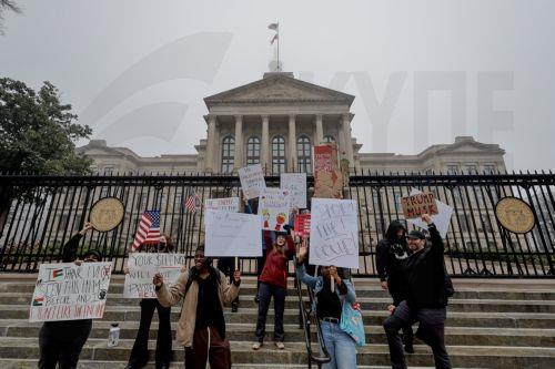 epaselect epa11899564 Demonstrators participate in a pro-democracy protest against recent Trump administration policies and actions outside the Georgia State Capitol in downtown Atlanta, Georgia, USA, 15 February 2025. The small group marched and chanted against US President Trump, Elon Musk, government worker firings, and mass immigration deportations. ...