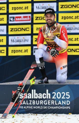 epa11900659 Loic Meillard of Switzerland poses with his Men's Slalom gold medal and his Men's Giant Slalom bronze medal after the podium for the Men's Slalom at the FIS Alpine Skiing World Championships in Saalbach Hinterglemm, Austria, 16 February 2025.  EPA/ANNA SZILAGYI