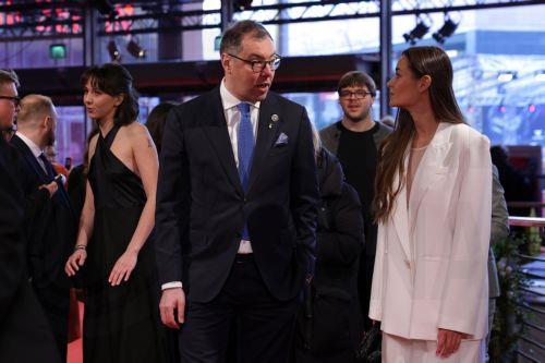 epa11910282 Ukraine's Ambassador to Germany Oleksii Makeiev (C) and Executive Producer Zoya Lytvyn (R) arrive for the screening of 'Strichka Chasu (Timestamp)' during the 75th Berlin International Film Festival, in Berlin, Germany, 20 February 2025. The Berlinale runs from 13 to 23 February 2025.  EPA/CHRISTOPHER NEUNDORF