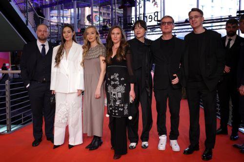 epa11910286 Producers Zoya Lytvyn (2-L), Olha Bregman (3-L), Natalia Libet (3-R) and guests arrive for the screening of 'Strichka Chasu (Timestamp)' during the 75th Berlin International Film Festival, in Berlin, Germany, 20 February 2025. The Berlinale runs from 13 to 23 February 2025.  EPA/CHRISTOPHER NEUNDORF