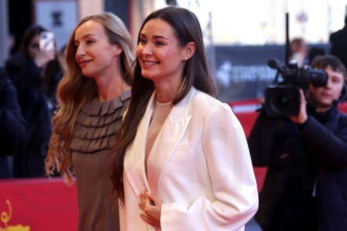 epa11910290 Producers Zoya Lytvyn (C) and Olha Bregman (L) arrive for the screening of 'Strichka Chasu (Timestamp)' during the 75th Berlin International Film Festival, in Berlin, Germany, 20 February 2025. The Berlinale runs from 13 to 23 February 2025.  EPA/CHRISTOPHER NEUNDORF