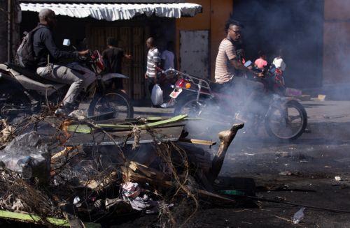 epa11920473 GRAPHIC CONTENT - The leg of an individual is shown among burnt rubble in Puerto Principe, Haiti, 23 February 2025. Several alleged gang members were lynched during a day of protests against insecurity in this nation, overwhelmed by a deep crisis that has worsened in recent years due to the violence of armed gangs, whose actions caused more than...