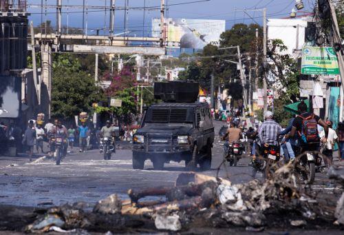 epa11920474 GRAPHIC CONTENT - An armored police vehicle patrols in the middle of a street in Puerto Principe, Haiti, 23 February 2025. Several alleged gang members were lynched during a day of protests against insecurity in this nation, overwhelmed by a deep crisis that has worsened in recent years due to the violence of armed gangs, whose actions caused...