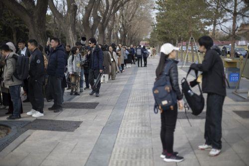 epa11937245 Members of the media queue outside of the Great Hall of People in Beijing, China, 03 March 2025. China's major annual political meetings, known as 'Lianghui' or 'Two Sessions,' will begin on 04 March with the opening of the Chinese People's Political Consultative Conference (CPPCC), while the National People's Congress (NPC) will open on 05...