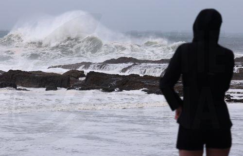epa11941632 People are seen at Snapper Rocks on the Gold Coast, Queensland, Australia, 05 March 2025. Tropical cyclone Alfred is set to bring heavy rainfall and damaging winds, and is expected to impact a part of the Australian coast for the first time in more than 50 years. Residents are advised to prepare for incoming tropical cyclone Alfred which is due...