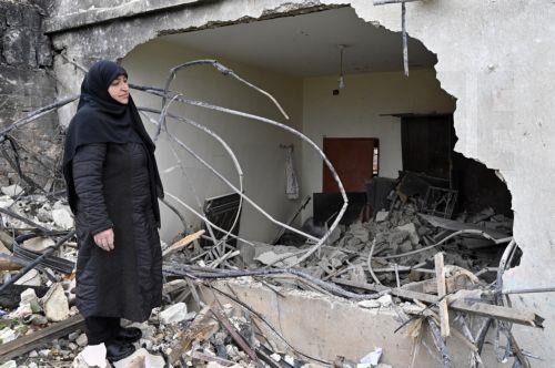 epa11947117 Zainab Nasrallah, 53, inspects her house destroyed by Israeli forces, ahead of International Women's Day celebrations in the southern Lebanese village of Houla, Lebanon, 07 March 2025. Nasrallah remained in her village for nine months during the fighting between Hezbollah and Israeli forces before moving to a nearby village, then fleeing to...