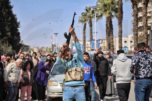 epaselect epa11952273 A Syrian armed man fires into the air during the funeral of a member of the Syrian security forces killed in an attack by groups loyal to the ousted President Bashar al-Assad, in Hama province, Syria, 09 March 2025. According to the UK-based Syrian Observatory of Human Rights, more than 1,000 people were killed in two days of violence...