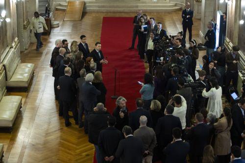 epa11957218 Portuguese Prime Minister Luis Montenegro (C-L) talks to the press after the rejection of the government motion of confidence at the Portuguese Parliament in Lisbon, Portugal, 11 March 2025. The motion of confidence comes in response to growing questions about the prime minister's family's business activities.  EPA/JOSE SENA GOULAO