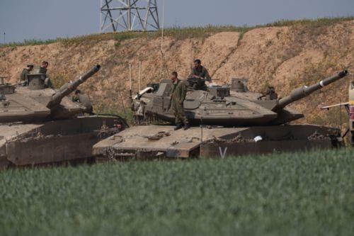 epa11971170 Israeli soldiers on their tanks next to the border with the Gaza Strip, as seen from an undisclosed location in Israel, 18 March 2025. The Israeli forces on 18 March confirmed they were carrying out 'extensive strikes' on targets in the Gaza Strip, following an Israeli prime minister's statement which ended the ceasefire in place since 19...