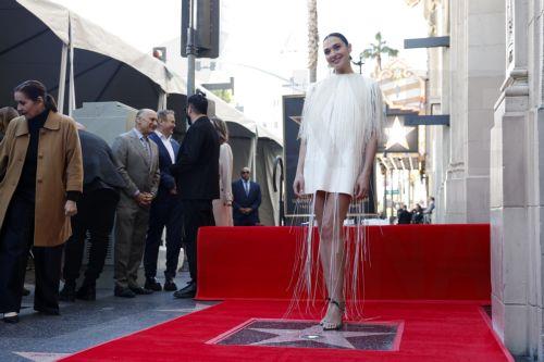 epa11972841 Israeli actor Gal Gadot poses by her newly unveiled Hollywood Walk of Fame star during a ceremony in her honor in Los Angeles, California, USA, 18 March 2025.  EPA/CAROLINE BREHMAN