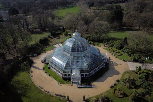 epa11989617 An aerial photograph taken by drone shows people walking around Sefton Park Palm House in Liverpool, Britain, 26 March 2025.  EPA/ADAM VAUGHAN