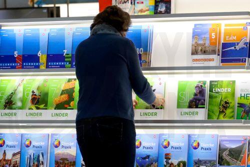 epa11989622 A worker prepares a bookstand one day ahead of the Leipzig Book Fair in Leipzig, Germany, 26 March 2025. Around 3000 exhibitors and 250,000 visitors are expected to attend the fair, which will run from 27 to 30 March. This year's guest of honor is Norway.  EPA/FILIP SINGER