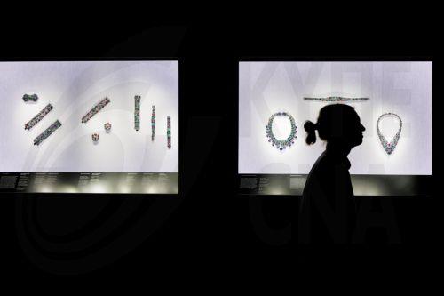 epa12019951 A gallery assistant poses with Cartier jewellery items on display during a photocall for V&A'S major exhibition 'Cartier' in London, Britain, 09 April 2025. The exhibition features more than 350 objects and explores French jewellery house's legacy of art, design and craftsmanship since the beginning of the 20th century and runs from 12 April to...