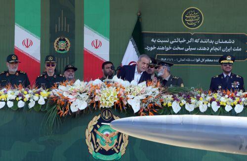 epa12038385 Iranian president Masoud Pezeshkian (C) watches as a drone passes by during the annual Army Day celebration, in Tehran, Iran, 18 April 2025. Top Iranian and US officials will hold second indirect negotiations on 19 April 2025 amid the ongoing tensions between the USA, Israel, and Iran.  EPA/ABEDIN TAHERKENAREH
