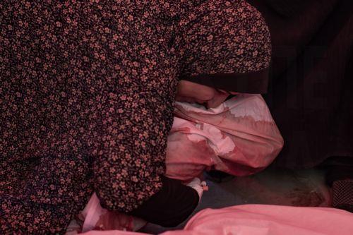 epa12038420 A mother holds the body of her daughter after an Israeli airstrike killed members of the Maqdad (Nasawi) family, in Jabalia, northern Gaza Strip, 18 April 2025. More than 51,000 Palestinians have been killed in the Gaza Strip, according to the Palestinian Ministry of Health, since Israel launched a military campaign in the strip in response to a...