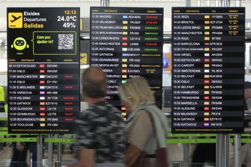 epa12062180 Two travelers walk past a departures info screen at Miguel Hernandez Alicante-Elche Airport in Elche, eastern Spain, 29 April 2025. Flights are operated without problems at the airport a day after a power outage hit large parts of Spain and spread to neighboring Portugal and France on 28 April, disrupting transport systems, internet connections,...
