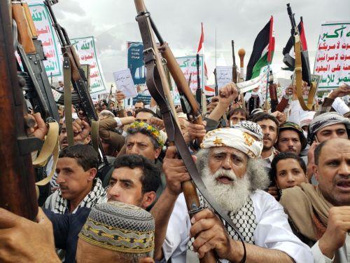 epa12069351 Houthi supporters shout slogans and hold up their weapons during an anti-USA protest, in Sana'a, Yemen, 02 May 2025. Thousands of Houthi supporters demonstrated in Sana'a to protest against US airstrikes targeting several Yemeni cities since mid-March. Houthis have vowed to continue military operations against Israel and US ships in waters...