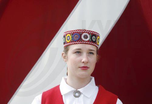 epa12072769 A woman in traditional costume attends the Latvian Independence Restoration Day military parade in Talsi, Latvia, 04 May 2025. The day marks a national holiday celebrated annually with the traditional military parade taking place in a different regional center since 2013.  EPA/TOMS KALNINS