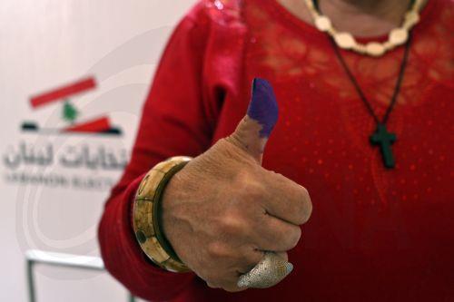epa12072823 A Lebanese woman shows her ink-stained thumb after casting her vote for the Municipality elections at a polling station in Deir El Qamar, in the Chouf District of the Mount Lebanon Governorate, southeast of Beirut, Lebanon, 04 May 2025. The first phase of the Lebanese municipal elections is being held on 04 May after they were postponed in 2023...