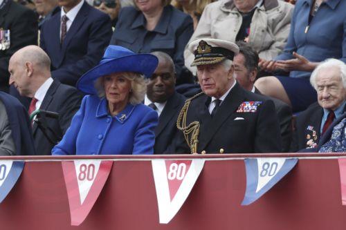 epa12075132 Britain's Queen Camilla (L) and King Chalres III (R) watch the military procession to commemorate the 80th anniversary of Victory in Europe (VE Day) in London, Britain, 05 May 2025. Around 1,000 UK service personnel from the Royal Navy, the Royal Marines, the British Army and the Royal Air Force will join the procession, including personnel from...