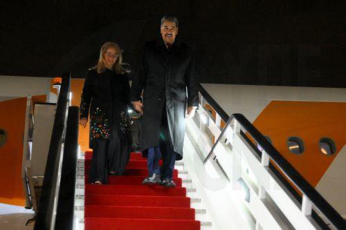 epa12079157 A handout photo made available by Photo host Agency RIA Novosti shows Venezuelan President Nicolas Maduro (R) accompanied by his wife Cilia Flores (L), speaking with journalists upon his arrival at Vnukovo airport to attend the celebrations to mark this year's 80th anniversary of Russia's Victory in the Great Patriotic War of 1941-1945, in...