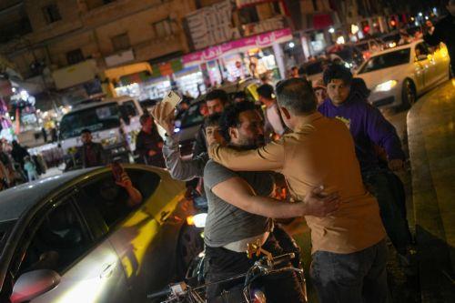 epa12098039 Syrians celebrate on the street after the US announced the lifting of sanctions on Syria, in Idlib, Syria, 13 May 2025. During his visit to Riyadh, US President Donald J. Trump said he will be ordering the cessation of sanctions against Syria.  EPA/AHMAD FALLAHA