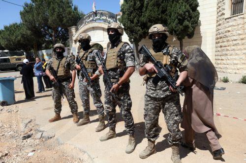 epa12129983 Memebers of State Security Service stand guard outside a polling station during the municipal elections in Nabatieh, southern Lebanon, 4 May 2025. The final phase of the Lebanese municipal elections is being held on 24 May after they were postponed in 2023 due to the financial and economic crisis the country is going through, and the lack of...