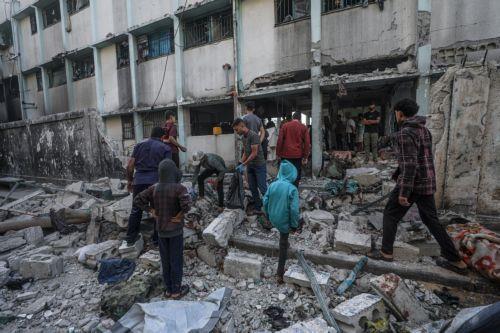 epa12136521 Internally displaced Palestinians inspect the rubble at the Al Jerjawi school following an Israeli airstrike in the Al Daraj neighborhood of Gaza City on 26 May 2025. According to the Palestinian Health Ministry in Gaza over 30 Palestinians were killed in the airstrike in the early hours of the morning. More than 53,900 Palestinians have been...