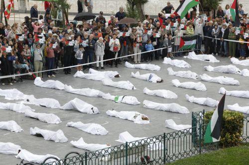 epa12149115 People lie wrapped in white blankets symbolizing Palestinian dead, as they stage a protest against the Israeli offensive in the Gaza Strip, in San Sebastian, Basque Country, Spain, 01 June 2025. More than 54,400 Palestinians have been killed in the Gaza Strip, according to the Palestinian Ministry of Health, since Israel launched a military...