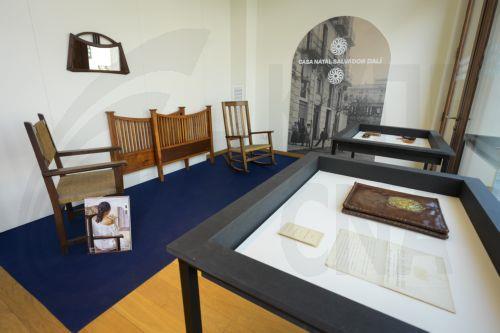 epa12155029 The chair Salvador Dali's sister Anna Mariam sat in for the portrait Girl with Her Back Turned is displayed at a museum in Figueres, Spain, 04 June 2025. Original furniture and objects from Salvador Dali's family were donated to the museum located at the Dali family home.  EPA/DAVID BORRAT