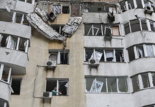 epa12159490 A man cleans debris from a window of a high-rise residential building struck by a drone during a massive overnight attack in Kyiv, Ukraine, 06 June 2025, amid the ongoing Russian invasion. At least three people were killed and more than 40 injured after Russia launched a large-scale combined assault using at least 44 missiles and nearly 407...