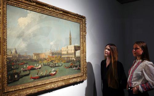 epa12159528 Staff at Christie's auction house look at a masterpiece by the Italian painter Giovanni Antonio Canal, titled 'Venice, the Return of the Bucintoro on Ascension Day', during an unveiling at Christie's in London, Britain, 06 June 2025. The Canaletto's work is expected to fetch around 20 million pounds at Christie's Old Masters Evening Sale in...