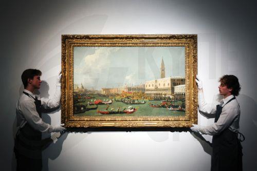 epa12159530 Staff at Christie's auction house look at a masterpiece by the Italian painter Giovanni Antonio Canal, titled 'Venice, the Return of the Bucintoro on Ascension Day', during an unveiling at Christie's in London, Britain, 06 June 2025. The Canaletto's work is expected to fetch around 20 million pounds at Christie's Old Masters Evening Sale in...