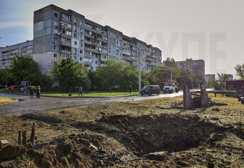 epa12161799 A shell crater at the site of a drone strike in Kharkiv, northeastern Ukraine, 07 June 2025, amid the Russian invasion. At least three people were killed and 21 others injured, including two children, after Russian forces launched an overnight combined attack by shock drones and rockets on Kharkiv and its suburbs, Kharkiv Mayor Ihor Terekhov...